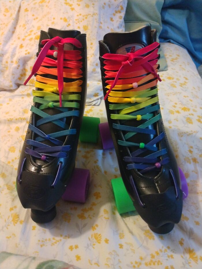Colorful rainbow-laced roller skates, showcasing weirdest pair of shoes theme.