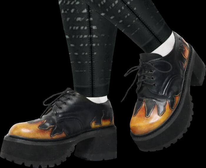 Person wearing unique platform shoes with flame details.
