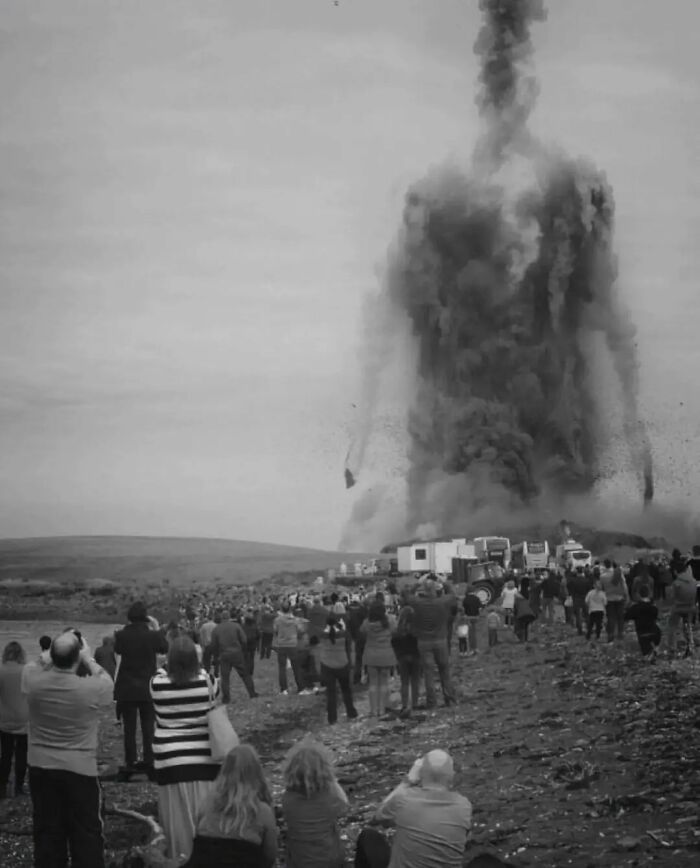 Crowd watching a large smoke formation resembling a human figure, shared on a popular Instagram page with 85K followers.