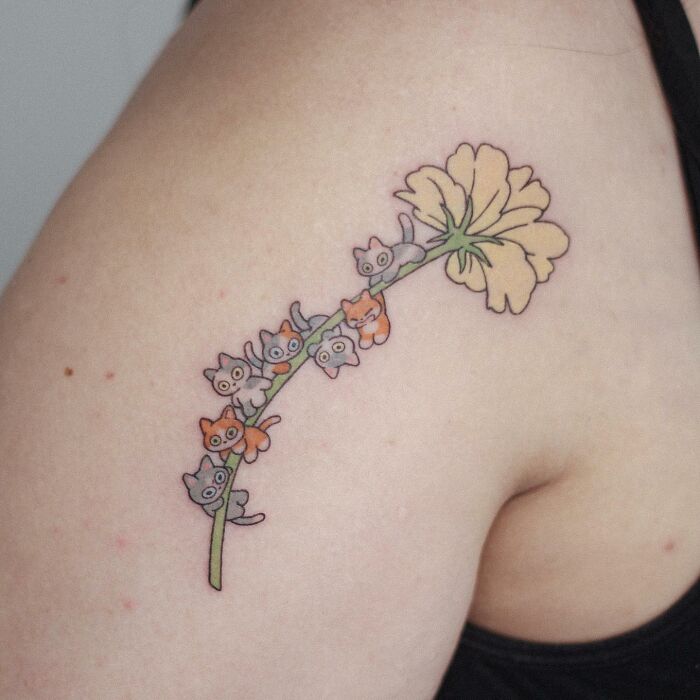 Tattoo of cute animals on a flower stem on a person's arm, showcasing animal-themed designs.