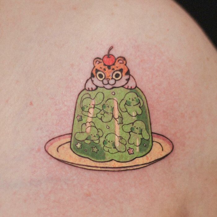 Adorable animal-themed tattoo of a tiger on green jelly with dog illustrations.