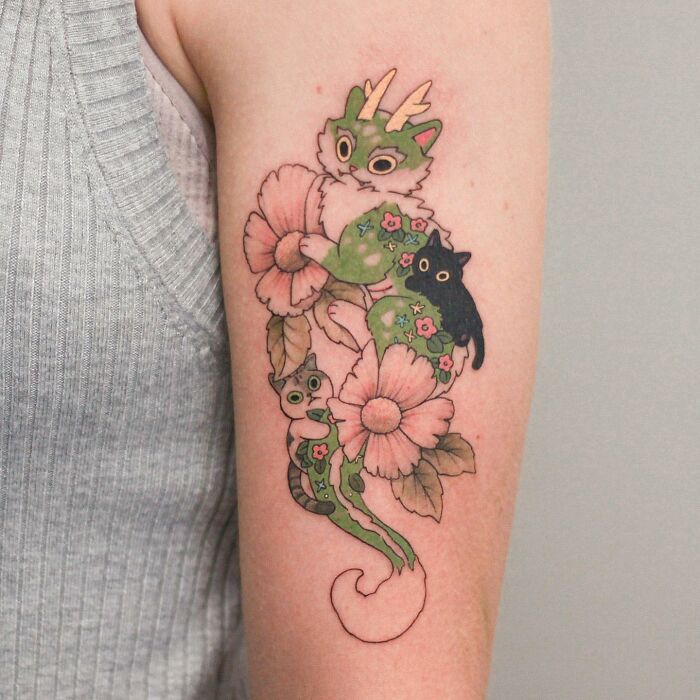 Adorable animal-themed tattoo design featuring whimsical creatures and flowers on an arm.