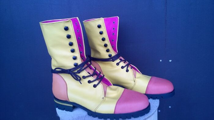 Colorful boots with yellow, pink, and orange panels, showcasing a weirdest pair of shoes design.