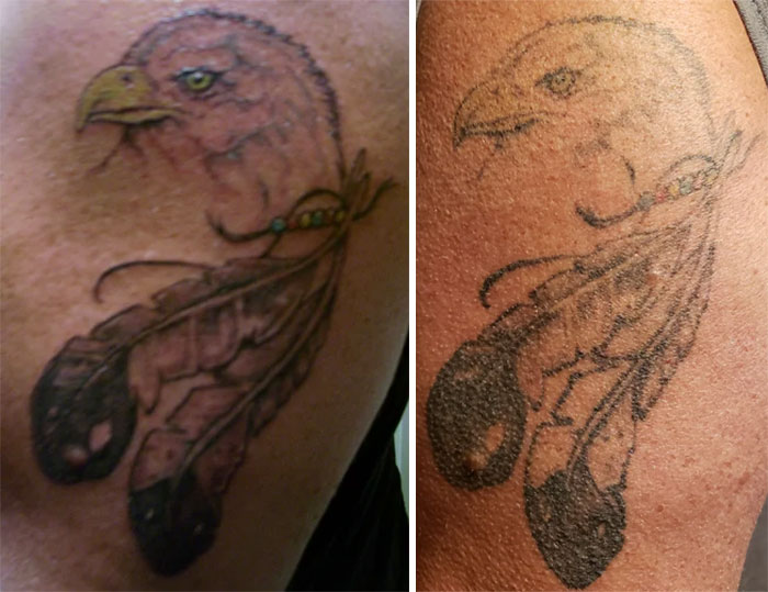 Aged tattoo of an eagle with feathers, showing ink changes over the years.