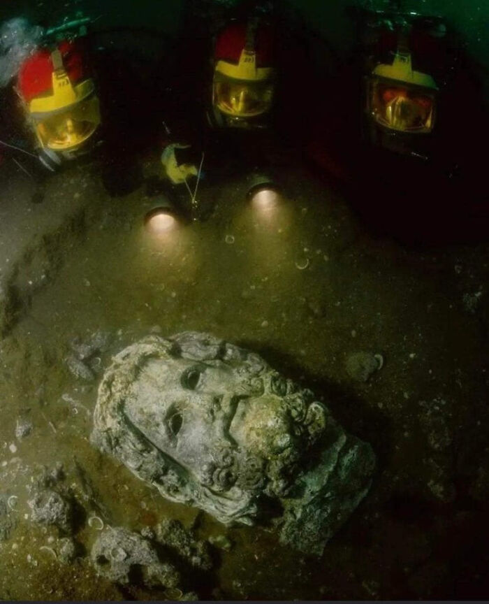 Divers Shining Lights On A Head Of Serapis, Found In The Sunken Egyptian Coastal Town Of Canopus