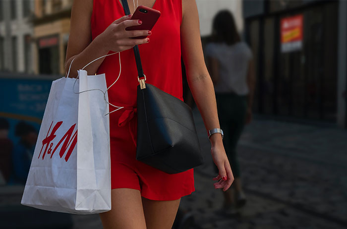 Women walking down the street with a shopping bag