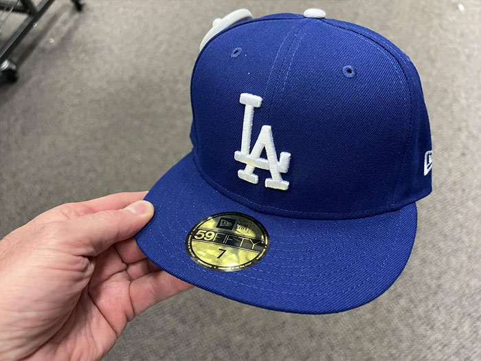 Person holding a blue hat