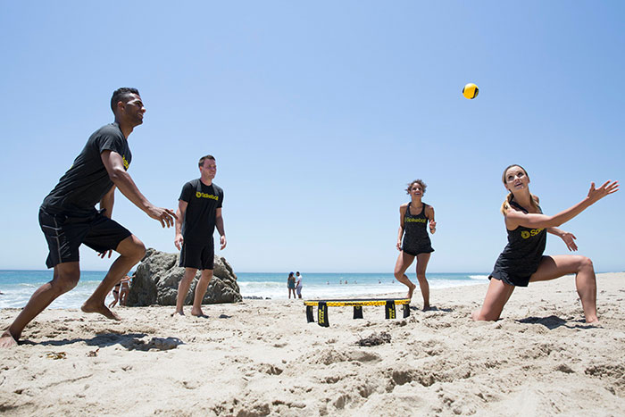 Friends playing volleyball at the beach