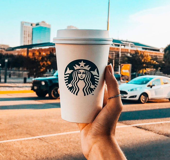 Woman holding Starbucks cup