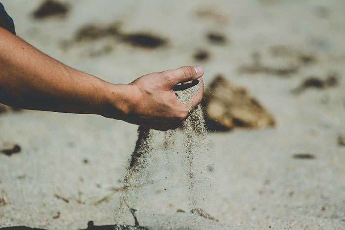 Person holding brown sand