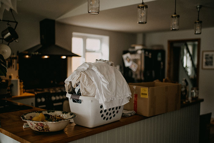 A laundry basket sitting on top of a wooden counter
