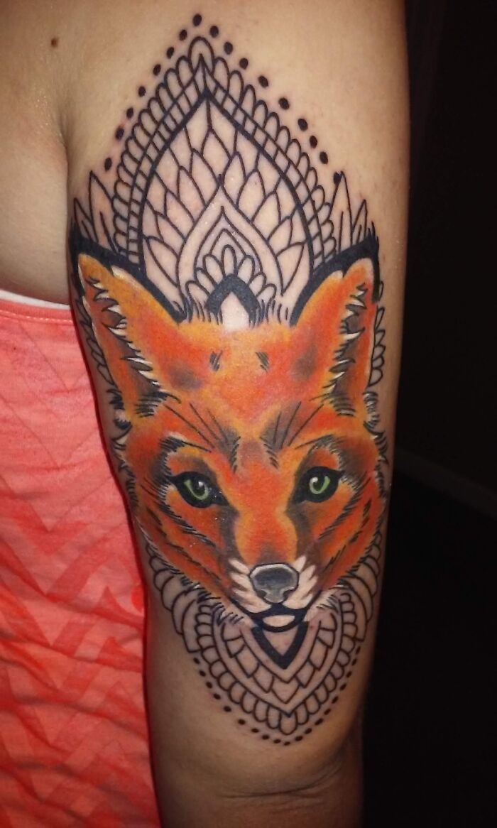 Coolest tattoo featuring a vibrant fox face with intricate geometric patterns on an arm.