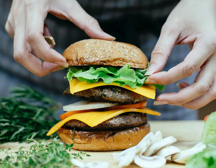 person collecting cheeseburger