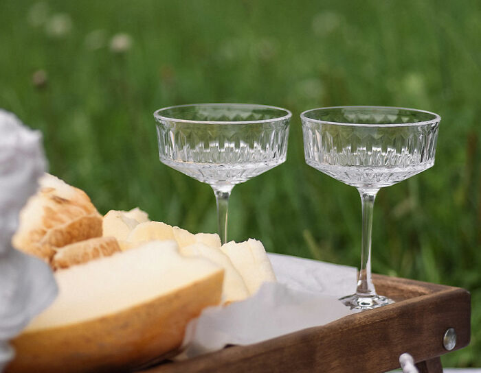two glasses near the melon on the tray 