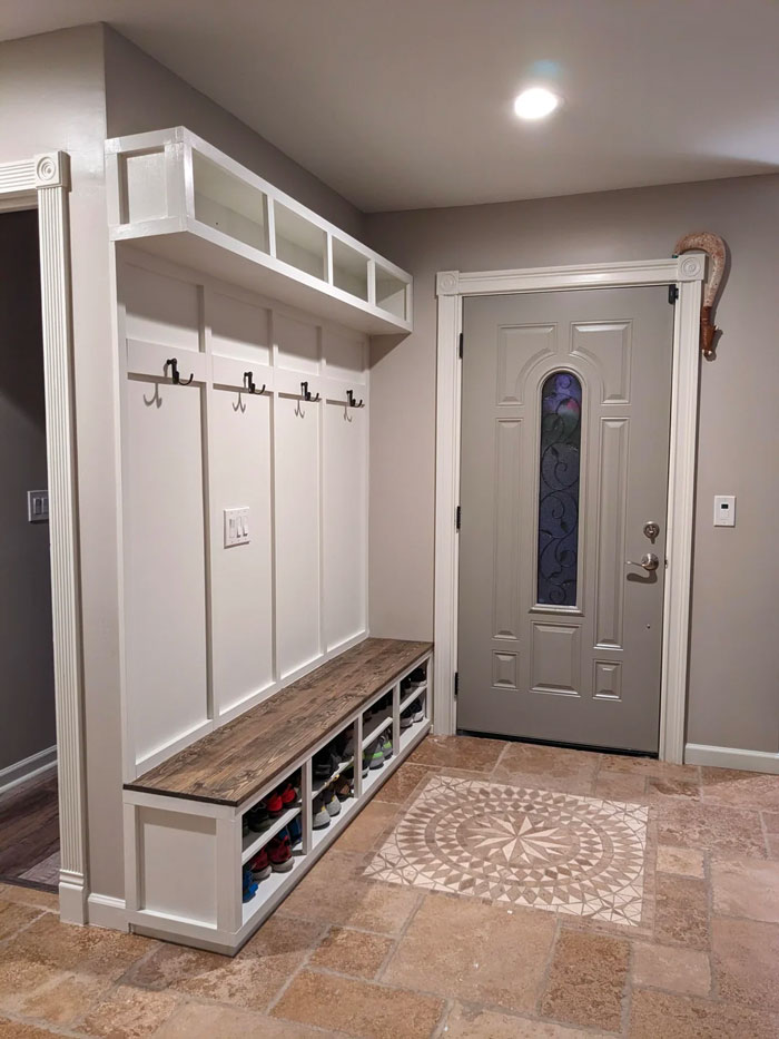 Entryway decoration with bench storage, wall hooks, patterned tile, and creative design inspiration.