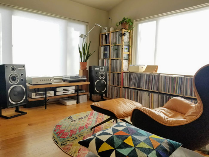 Creative decoration featuring a cozy reading nook with records, speakers, and a colorful rug for inspiration.