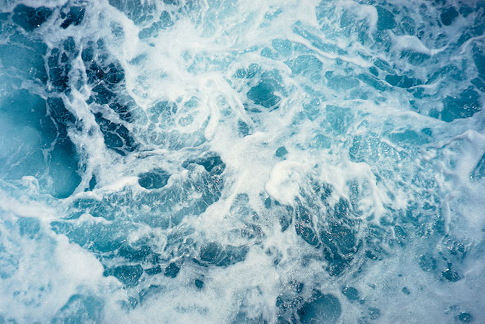 Ocean waves showing turbulent movement illustrating physics concepts in natural water dynamics and fluid motion.