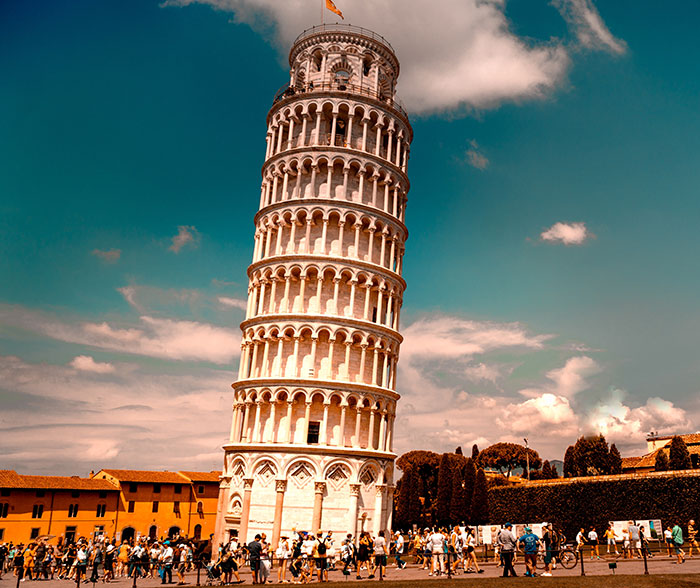 Persons observing the Leaning Tower of Pisa, illustrating fun facts about physics and gravitational force in a popular tourist spot.