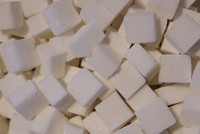 Close-up of sugar cubes illustrating interesting physics concepts related to structure and molecular arrangement.