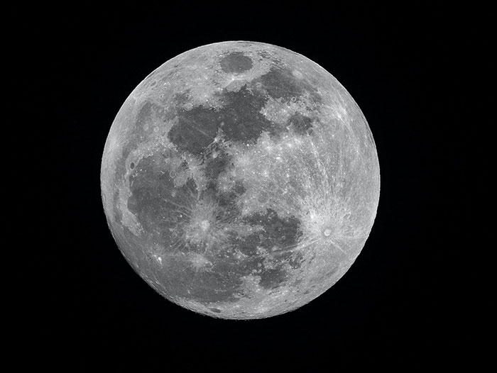 Full moon in the night sky showcasing celestial physics phenomena and inspiring curiosity about fun physics facts.