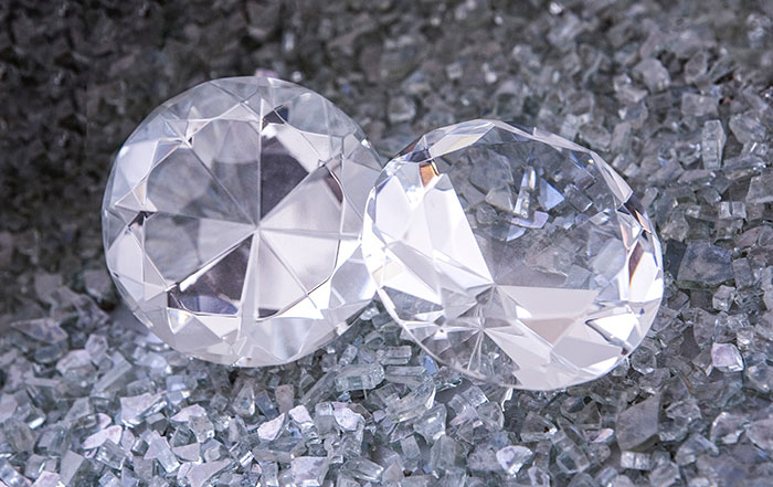 Two large and small diamonds placed on a bed of smaller crystals illustrating fun facts about physics.