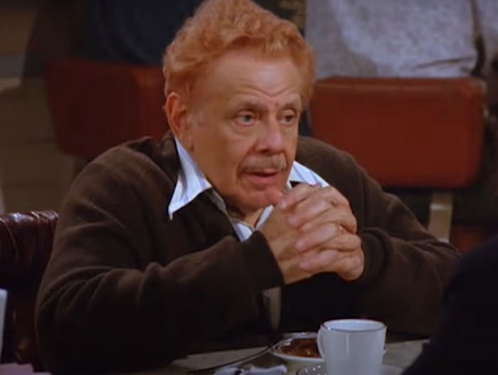 Frank Costanza wearing brown sweater 