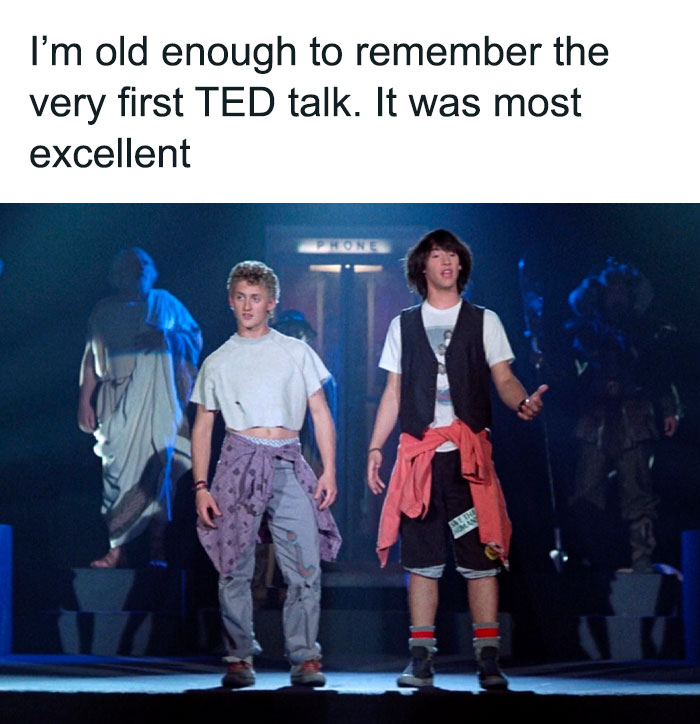 Two characters in casual 90s attire standing in front of a phone booth, referencing ‘old’ humor from memes.