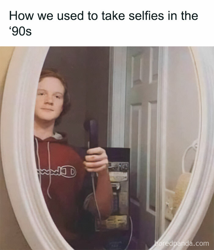 Gen X life: person takes mirror selfie in the '90s style, holding a corded phone.