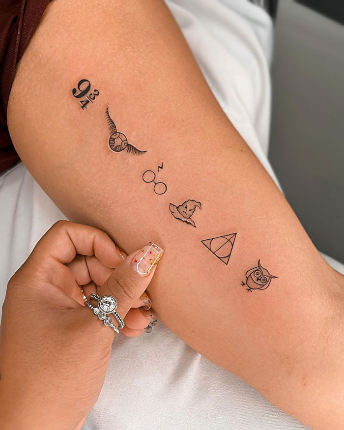 Minimalist Harry Potter tattoo designs on arm, featuring iconic symbols like glasses and owl.
