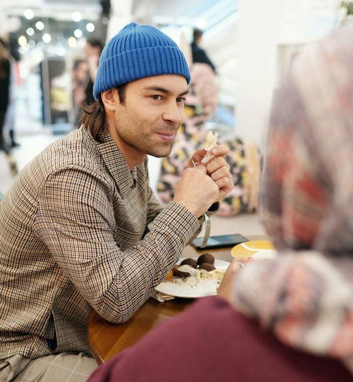 Person wearing blue hat and looking