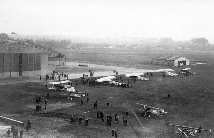 The Airport "Waalhaven" With Several Planes On The Ground And One In The Air. Rotterdam, Netherlands