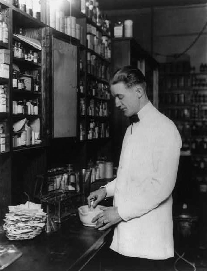 Pharmacist Mixing Medicine With Mortar And Pestle. 1923 March 5