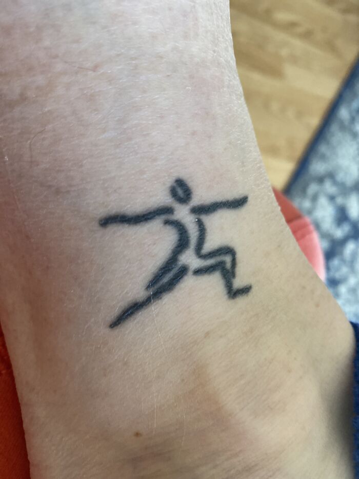 Minimalist tattoo of a dynamic running figure on an ankle.