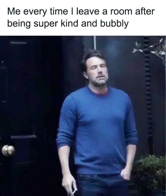 Man in blue sweater standing outside with eyes closed, showcasing introvert struggles with social exhaustion meme.