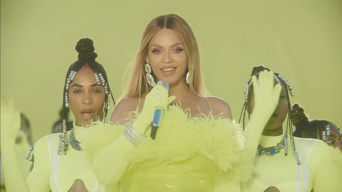 Photography of Beyonce singing in yellow dress