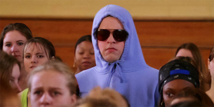 Damian standing with sunglasses and with a hood on his head