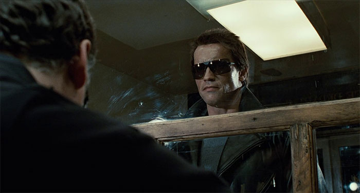 The Terminator standing with galsses