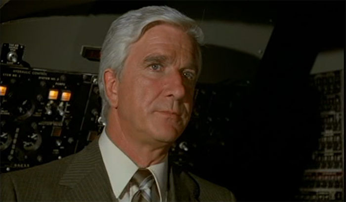 Rumack standing inside of airplane