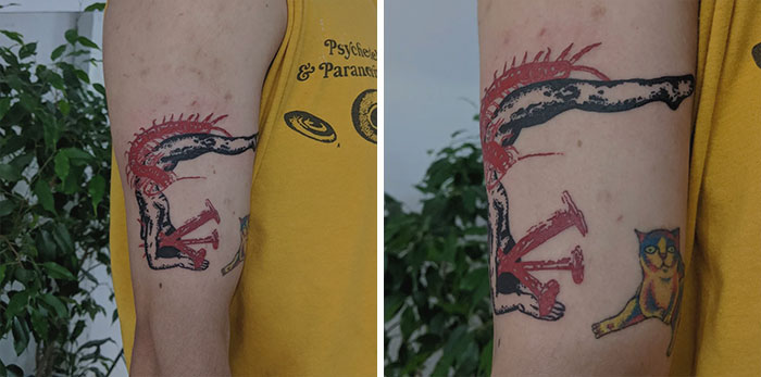 Arm with a unique red ink tattoo design featuring abstract elements and a small colorful cat, against a backdrop of green plants.