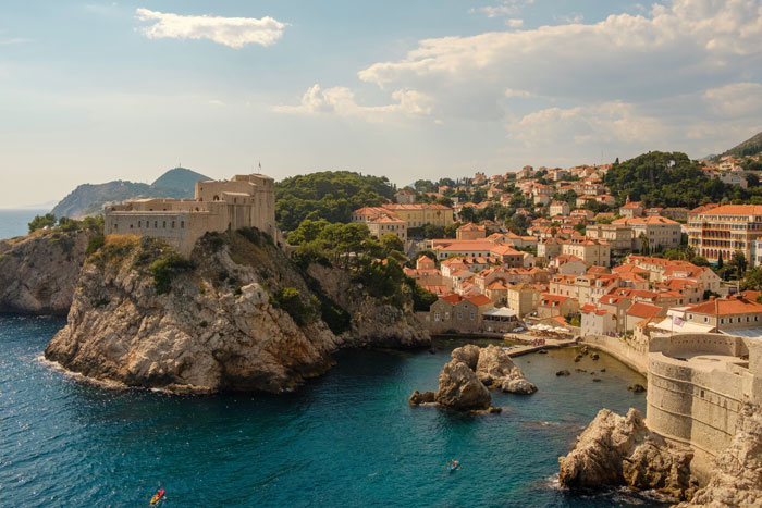 Houses with orange roofs near the seaside 
