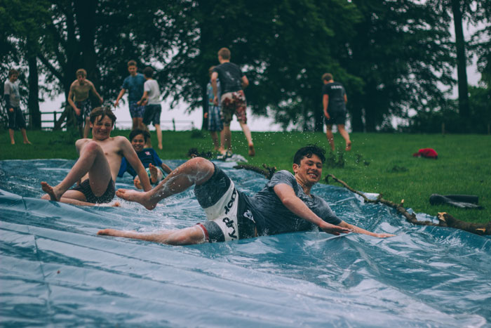 man playing on a slip-N-slide