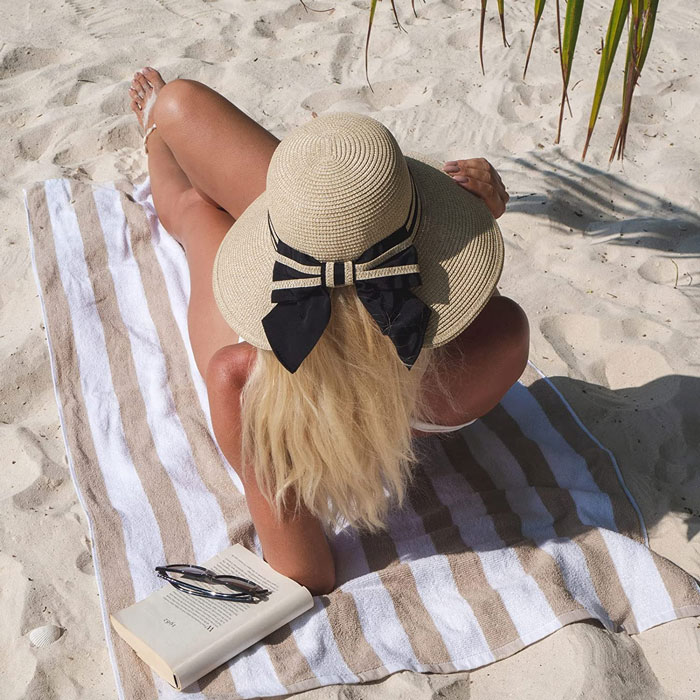 Woman wearing brown beach hat 
