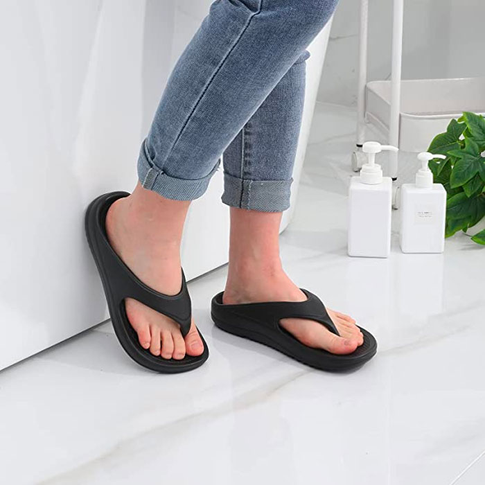 Woman wearing black flip flops 