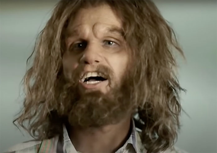 Nick standing and looking in Cavemen