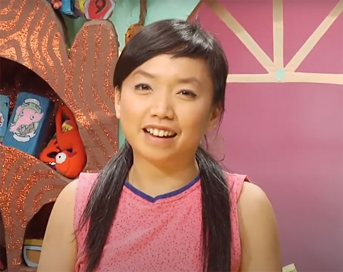 Thu Tran wearing pink standing in Food Party