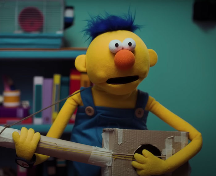 Yellow guy playing with guitar in Don't Hug Me, I'm Scared