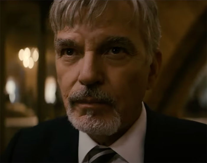 Billy wearing suit and looking in Goliath