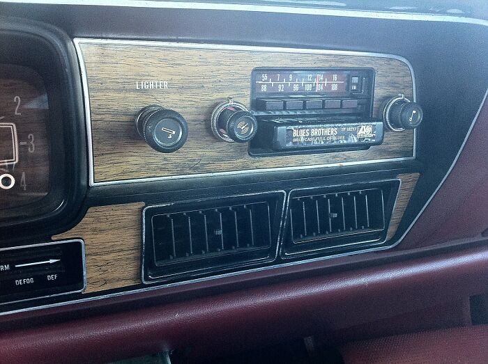 Vintage car dashboard featuring old gadgets including a classic radio and lighter, showcasing trendsetter technology of their time