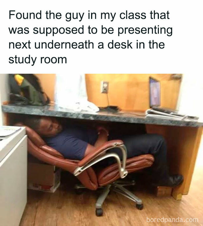 University student asleep under a desk in a study room, humorously captured instead of attending a presentation.