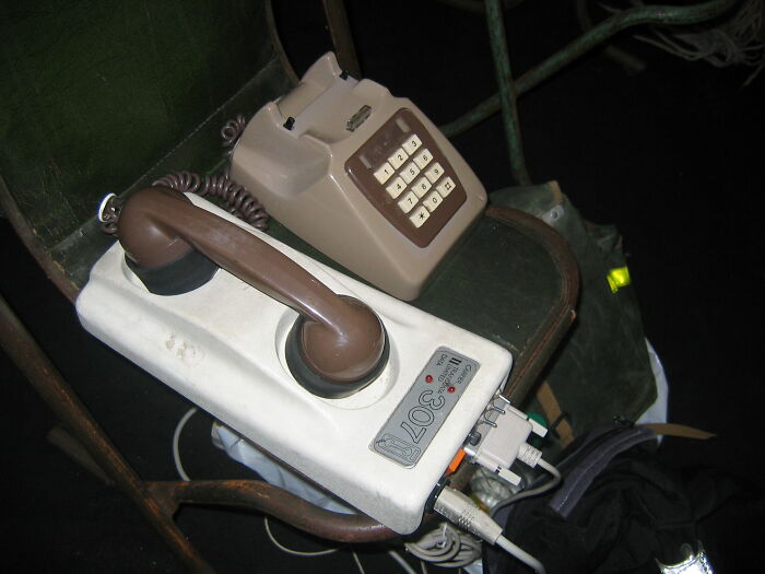 Vintage old gadgets with a classic rotary telephone and early electronic device showcasing old gadgets trendsetters.